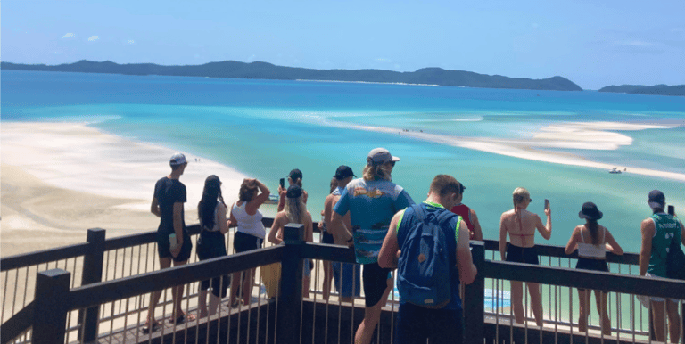 a group overlooking whitehaven beach on tour in australia