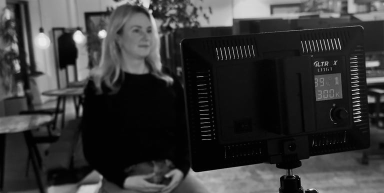 a woman sitting on a chair in a room while being interviewd