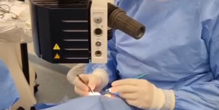 a woman in a surgical mask and a surgical instrument