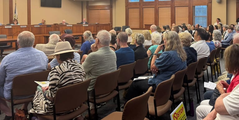 Ridgewood Town Hall event with people sitting and listening