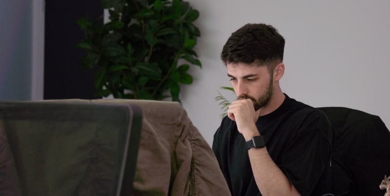 a man sitting at a desk with a laptop computer