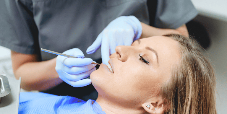 woman having her teeth examined by her dentist