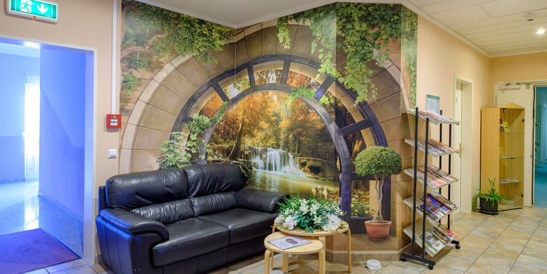 a living room with a couch and a wall mural