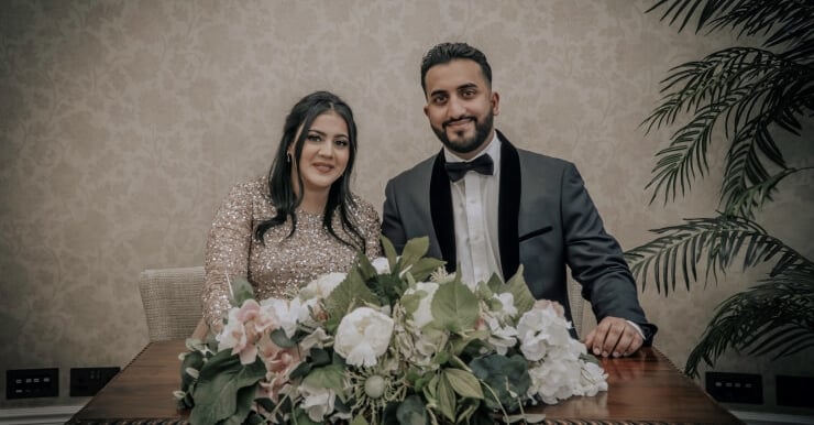 Bride and groom posing for a wedding photograph