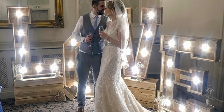 bride and groom posing for wedding video