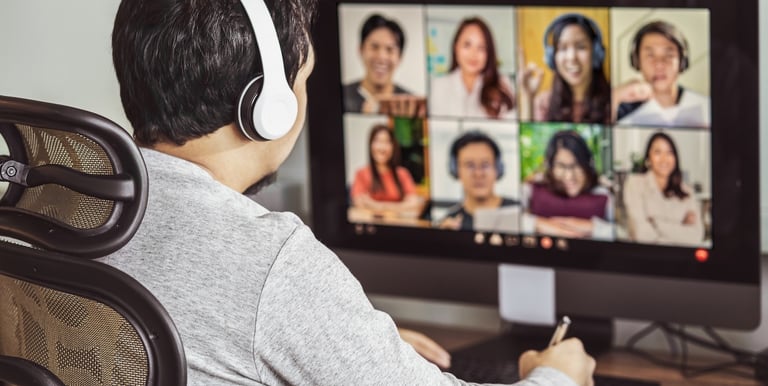 a man in headphones and headphones is sitting at a computer