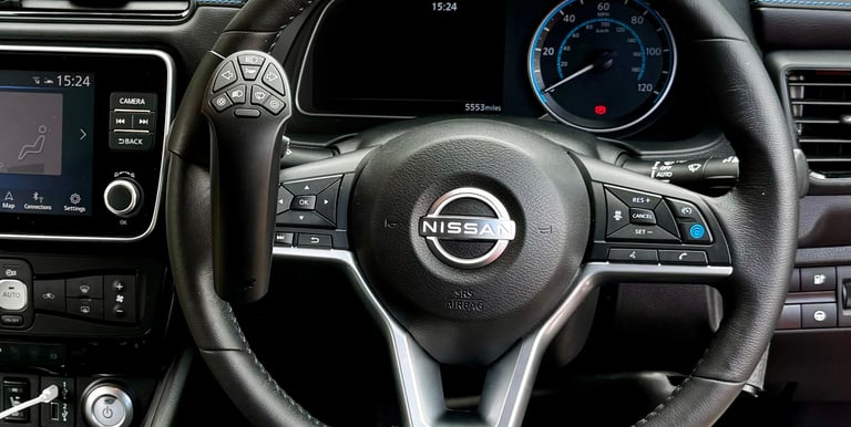 A Nissan steering wheel featuring an integrated remote control accessibility aid for disabled drivers.