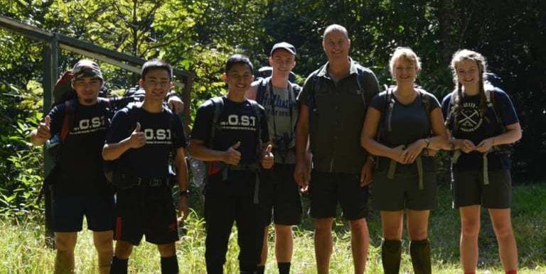 a group of people taking picture with the guide at the starting point of Maliau Basin trail