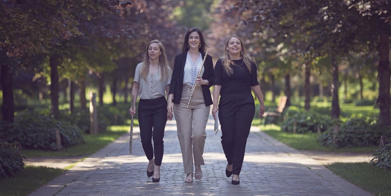 three women walking down a path in a park