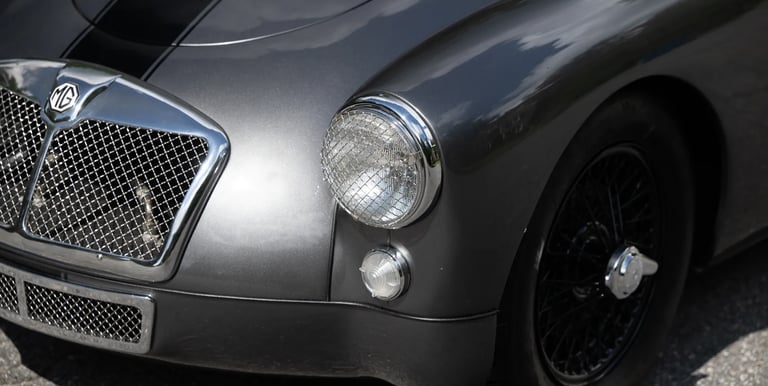 Close up view of the front of a silver 1958 MG MGA Roadster,