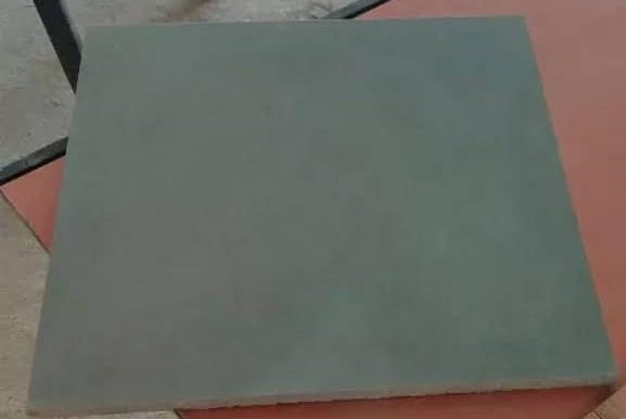 Square grey stone floor tile with a smooth matte finish for interior paving.