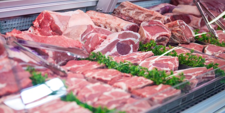 A Variety of Raw Meat arranged out on a market stall