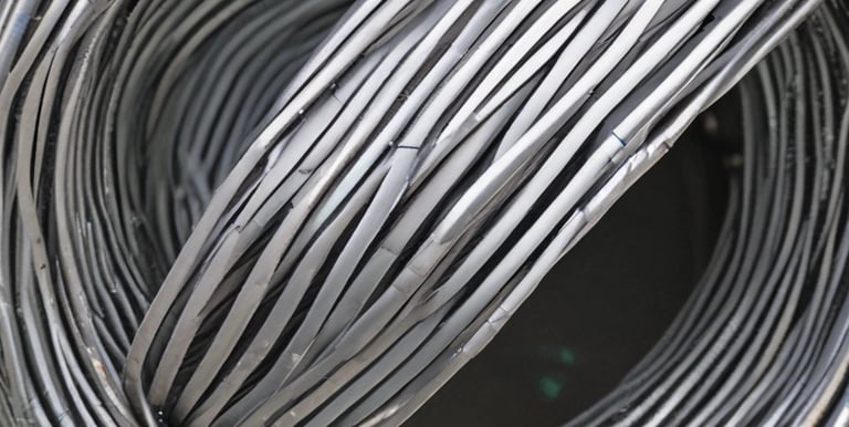 PVC coated wire mesh being inspected in a factory setting.