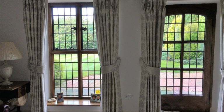 Bespoke curtains with double pleats and padded tie backs in the same fabric