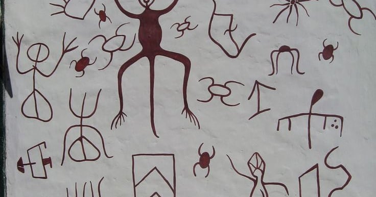 Art petroglyphs and tribal symbols depicting human figures and animals on a white wall of Guane
