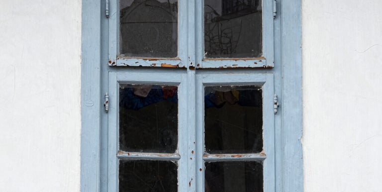 Laser cleaning in action on a historic stone façade with workers in protective gear nearby.