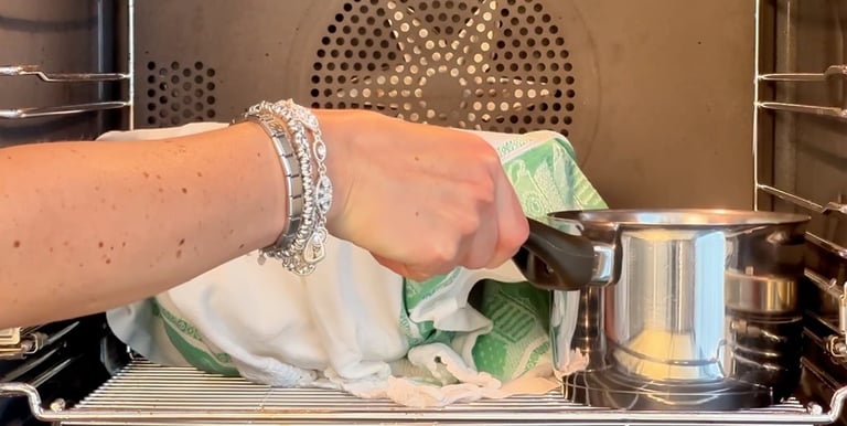 Let the dough rise next to a small pot of boiled water