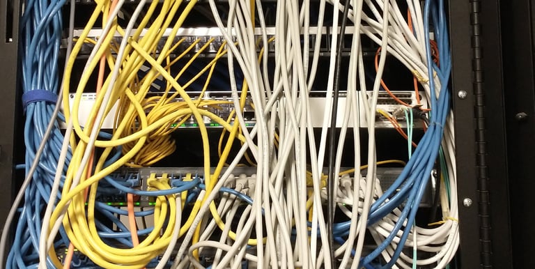 A mess of a cabling job in a network closet