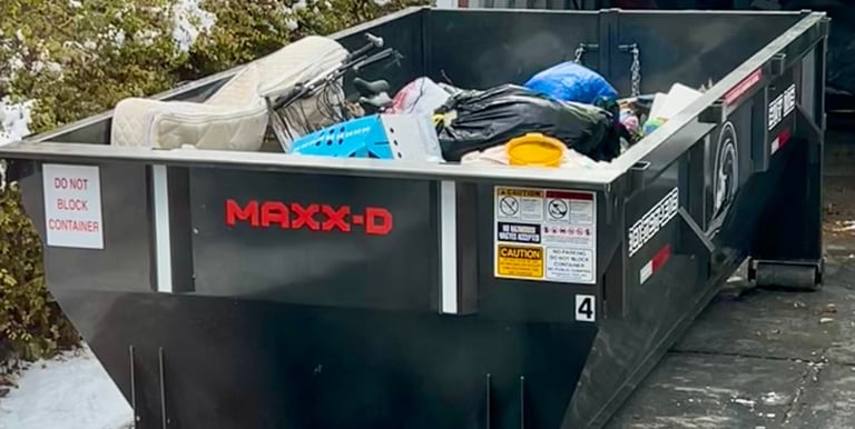 A dumpster loaded with junk from a house clean out