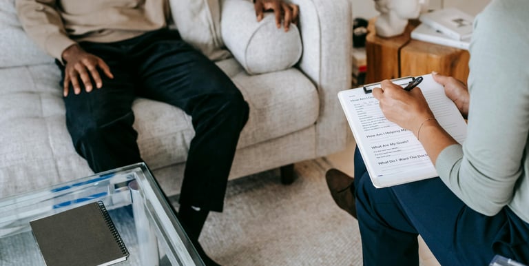 Person sitting down on a couch on therapy