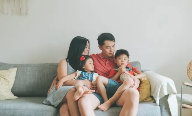 a happy family sitting on a sofa
