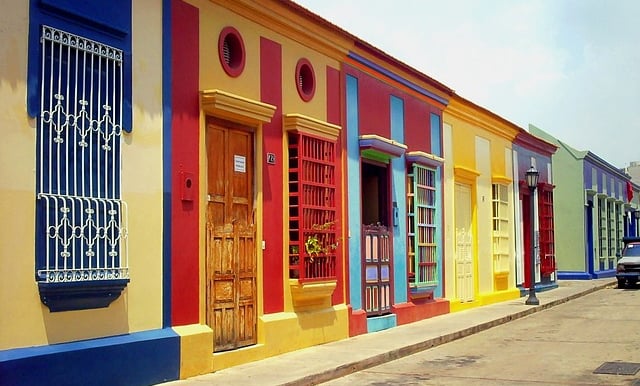 a row of colorful buildings with a car parked in front of them