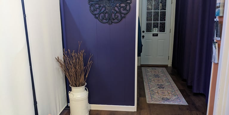 waiting area at Mud & Lotus Skincare, purple wall