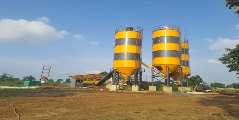 a concrete batching planter with two large yellow and black cement batching