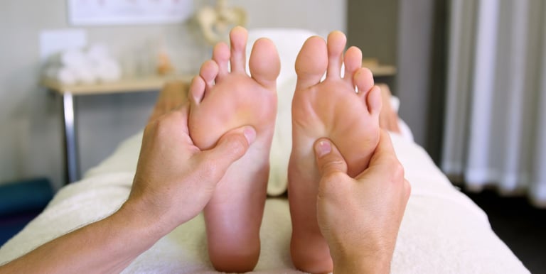 a person is getting a relaxing foot massage