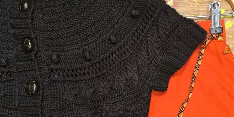 a black sweatered cardigand sweater with a handmade knitted cardigan