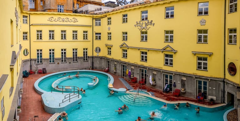 a pool with people swimming in a large pool