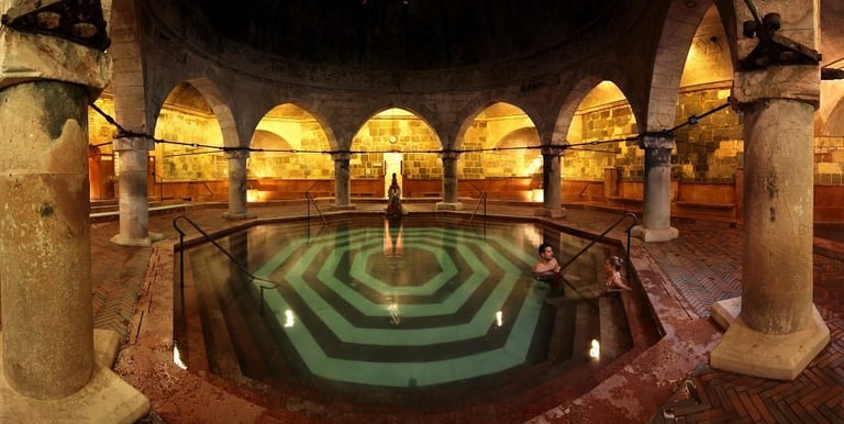a man standing in a large room with a large pool