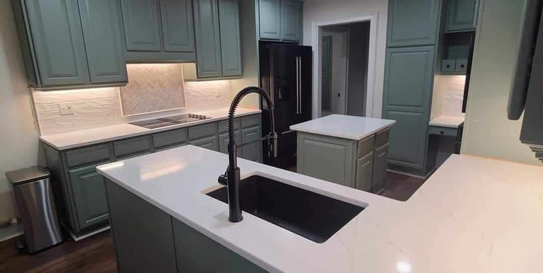 Quartz kitchen counters with matching full-height backsplash