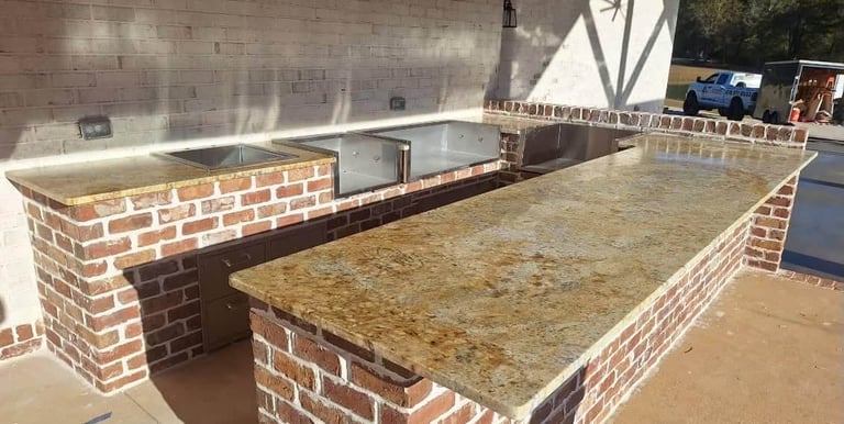 Granite countertop installed in outdoor kitchen with grill setup