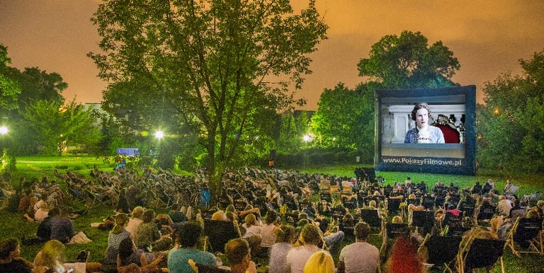 a large screen screen with people watching a movie