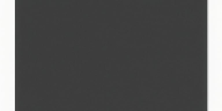 A laptop screen showing code and design elements in progress with a coffee cup nearby.