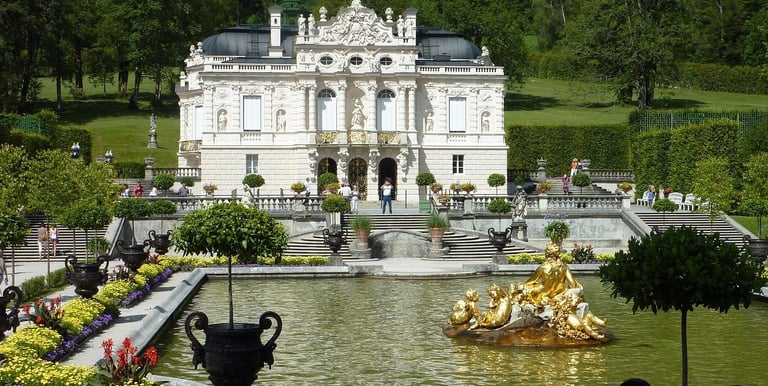 Linderhof Palace in Bavaria featuring golden fountain and ornate architecture in the formal gardens.