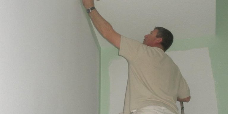 Professional painter applying wall paint in Boise home - Golden Hands Painting expert team