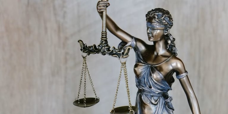 A statue of a lady with a scale justice justice and justice