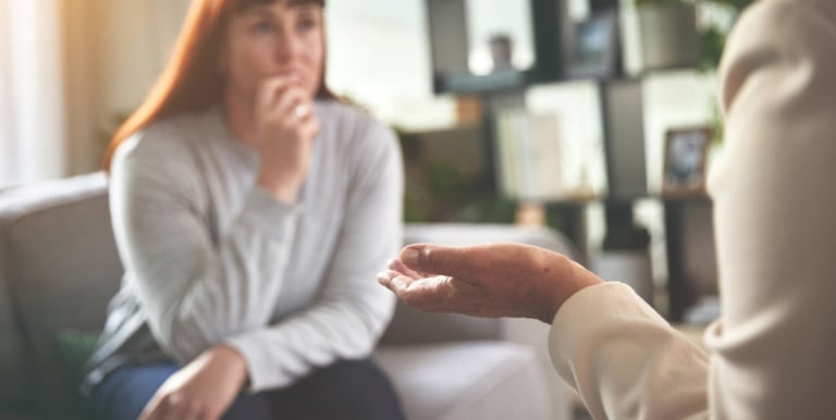 Woman listening carefully during a life coaching session.