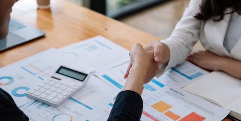 a woman in a business suit sitting at a desk