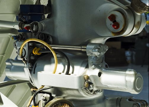 Close-up view of a metal mechanical component, likely part of an aircraft's landing gear assembly.