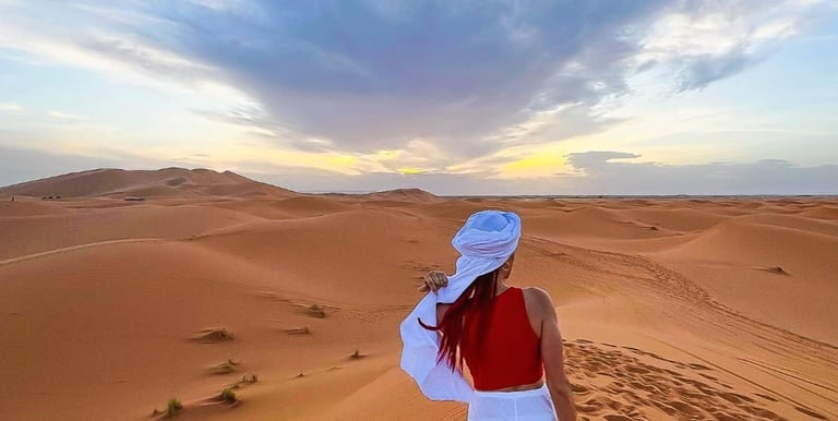 a woman in a white dress and a red scarf