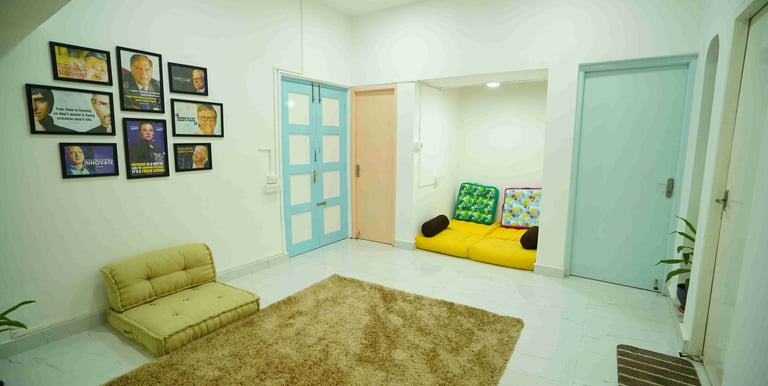 a living room with a couch and phot0 frames