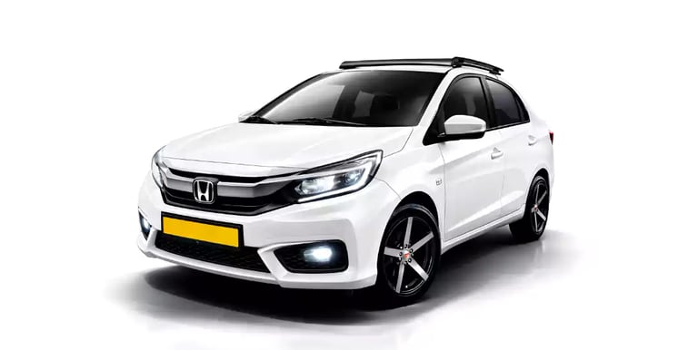 White Honda Amaze one way taxi by Saini taxi services with a luggage carrier rack