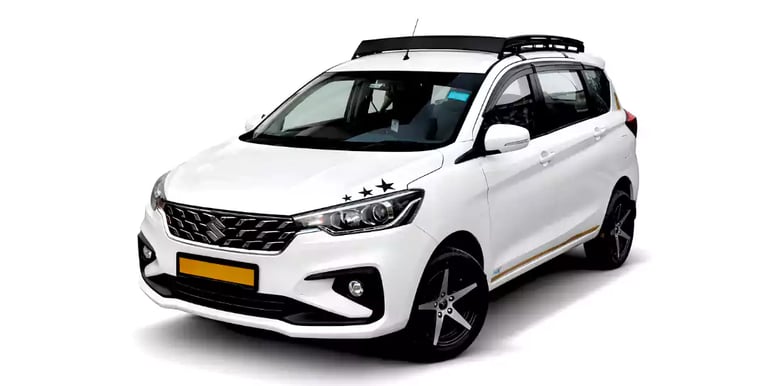 White Maruti Ertiga one way taxi by Saini taxi services with a luggage carrier rack
