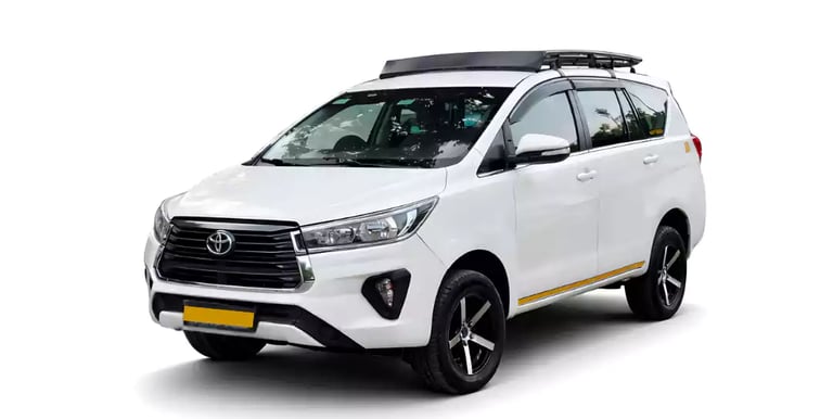 White Toyota Innova Crysta one way taxi by Saini taxi services with a luggage carrier rack