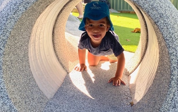 child playing in tunnel