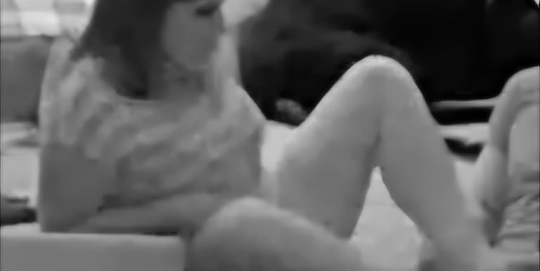 a woman sitting on a couch with a dog