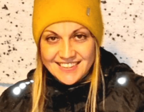 a woman in a yellow hat and black jacket
